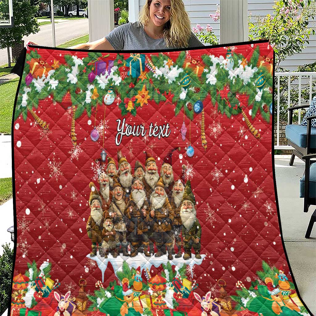 Red personalized quilt with quilted diamond pattern, Yule characters, and "Your text".
