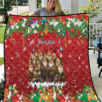Red personalized quilt with quilted diamond pattern, Yule characters, and "Your text".