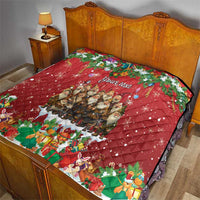 Red personalized quilt on bed with "Your text", snowy Yule scenes, and quilted diamonds.