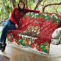 Red personalized quilt outdoors held up, "Your text" design with Yule characters and rabbits.
