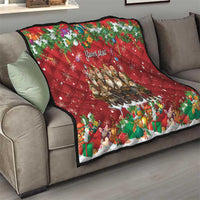 Red personalized quilt on gray sofa with "Your text" center and colorful holiday characters.