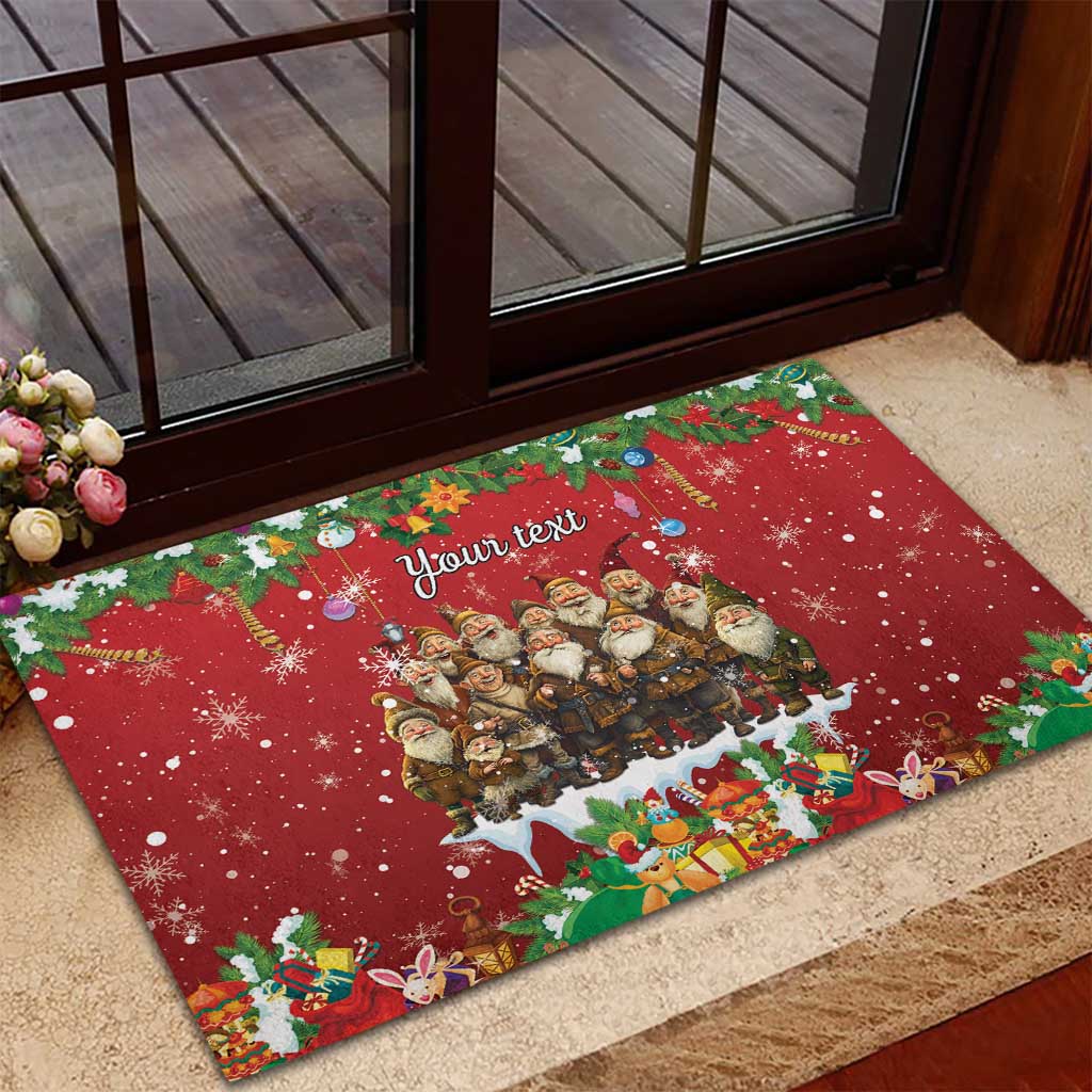 Red rubber doormat on doorstep with gnome group, 'Your text' and festive icons