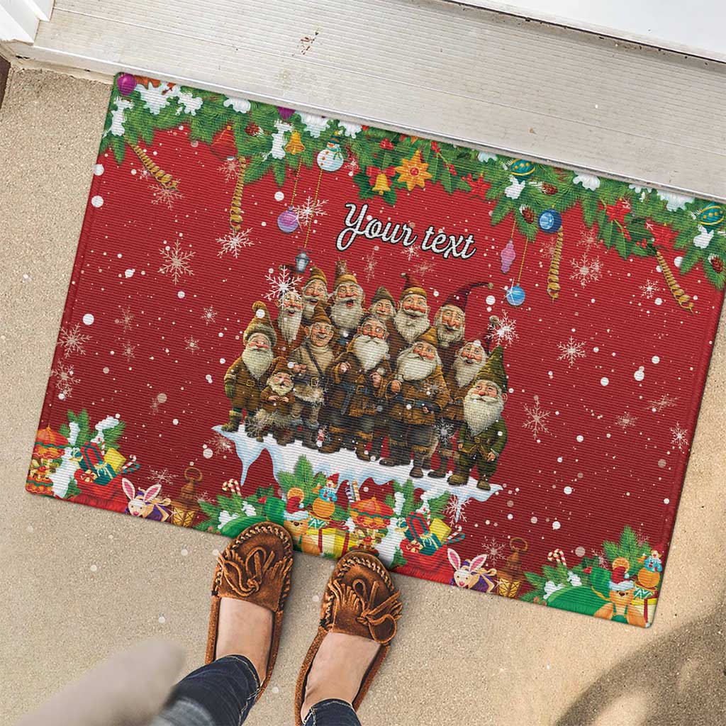 Red rubber doormat with gnome group, 'Your text', presents, and snowflakes