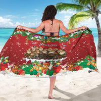 Red holiday sarong draped around shoulders, featuring gnome graphic and gifts