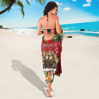 Red holiday sarong with gnome graphic and cursive personalized text on back