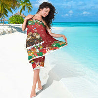 Red holiday sarong wrapped and held, featuring gnome crowd and colorful border