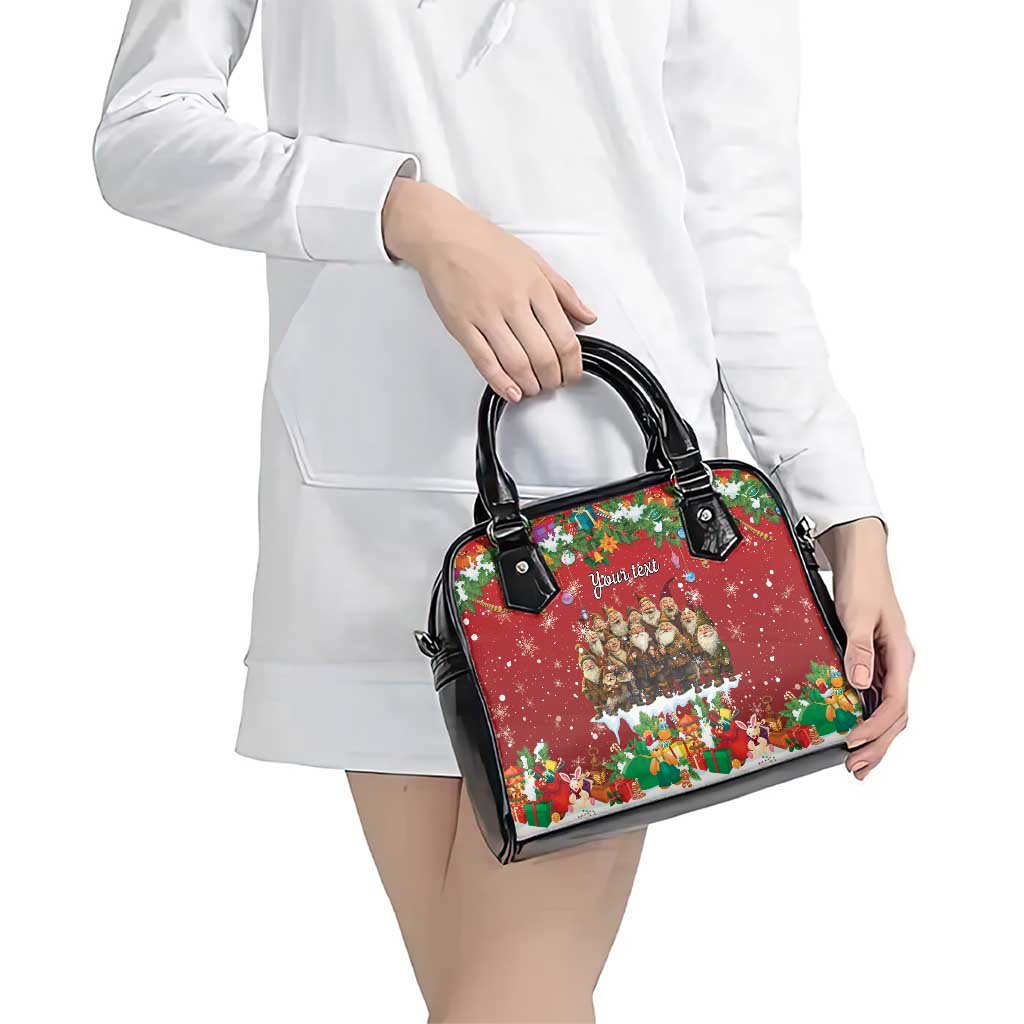 Red and black shoulder handbag with holiday print and black top handles.