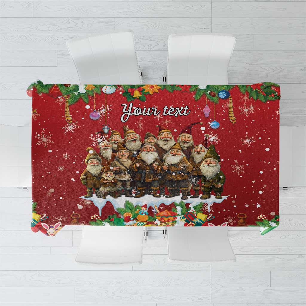 Red holiday tablecloth with gnome group and snowflake print, centered personalized text