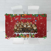 Red holiday tablecloth with gnome group and snowflake print, centered personalized text