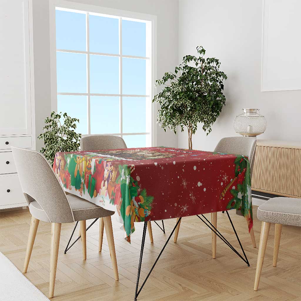 Red holiday tablecloth with multicolor gnome, deer, gift, and tree motifs on tabletop
