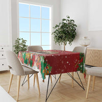 Red holiday tablecloth with multicolor gnome, deer, gift, and tree motifs on tabletop