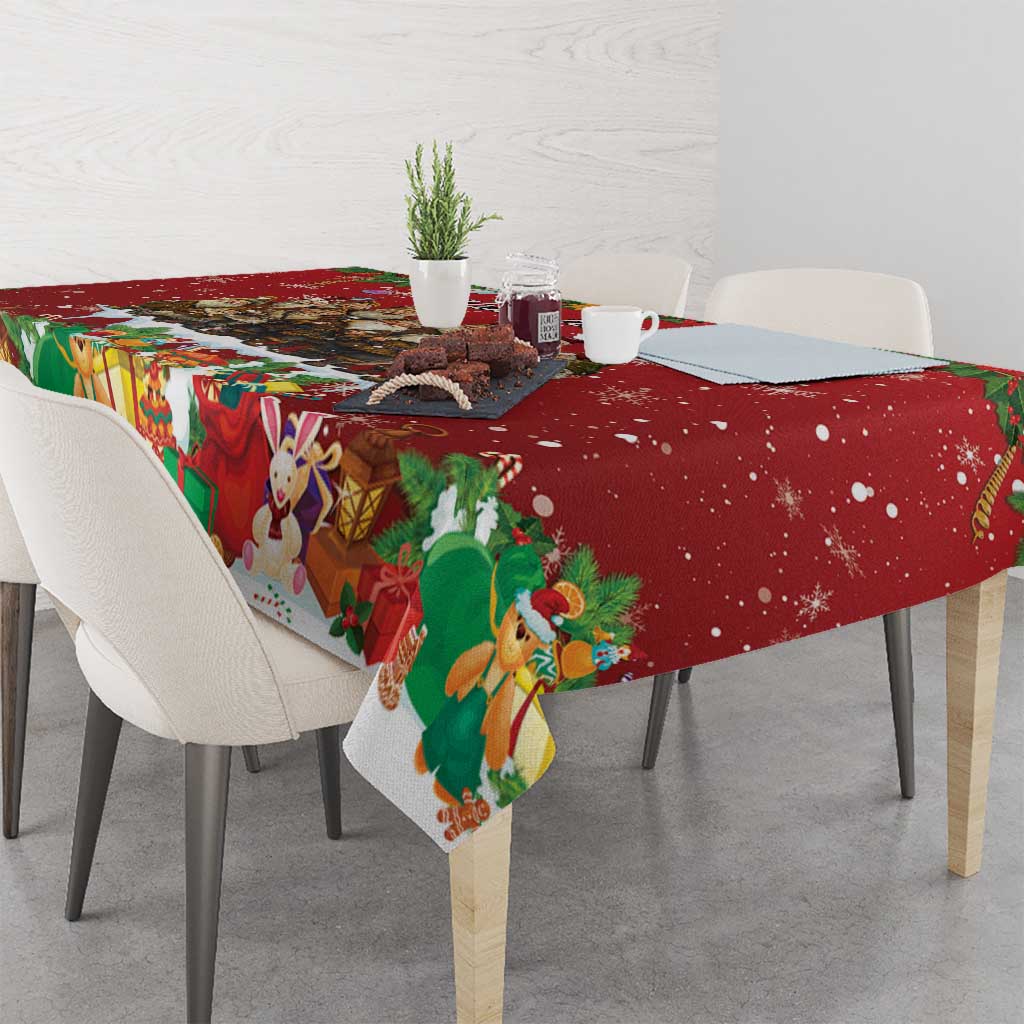 Red holiday tablecloth draped over table edge with character and gift pattern