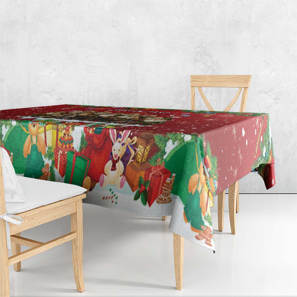 Red holiday tablecloth over table corner with hanging ornament and animal gift print