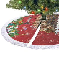 Red personalized tree skirt with white fringe edge, colorful holiday elf illustration