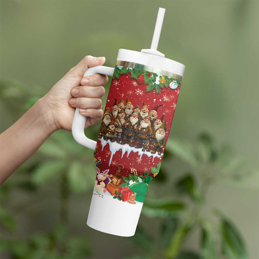Red holiday tumbler with white handle and straw, held in hand, festive character wrap