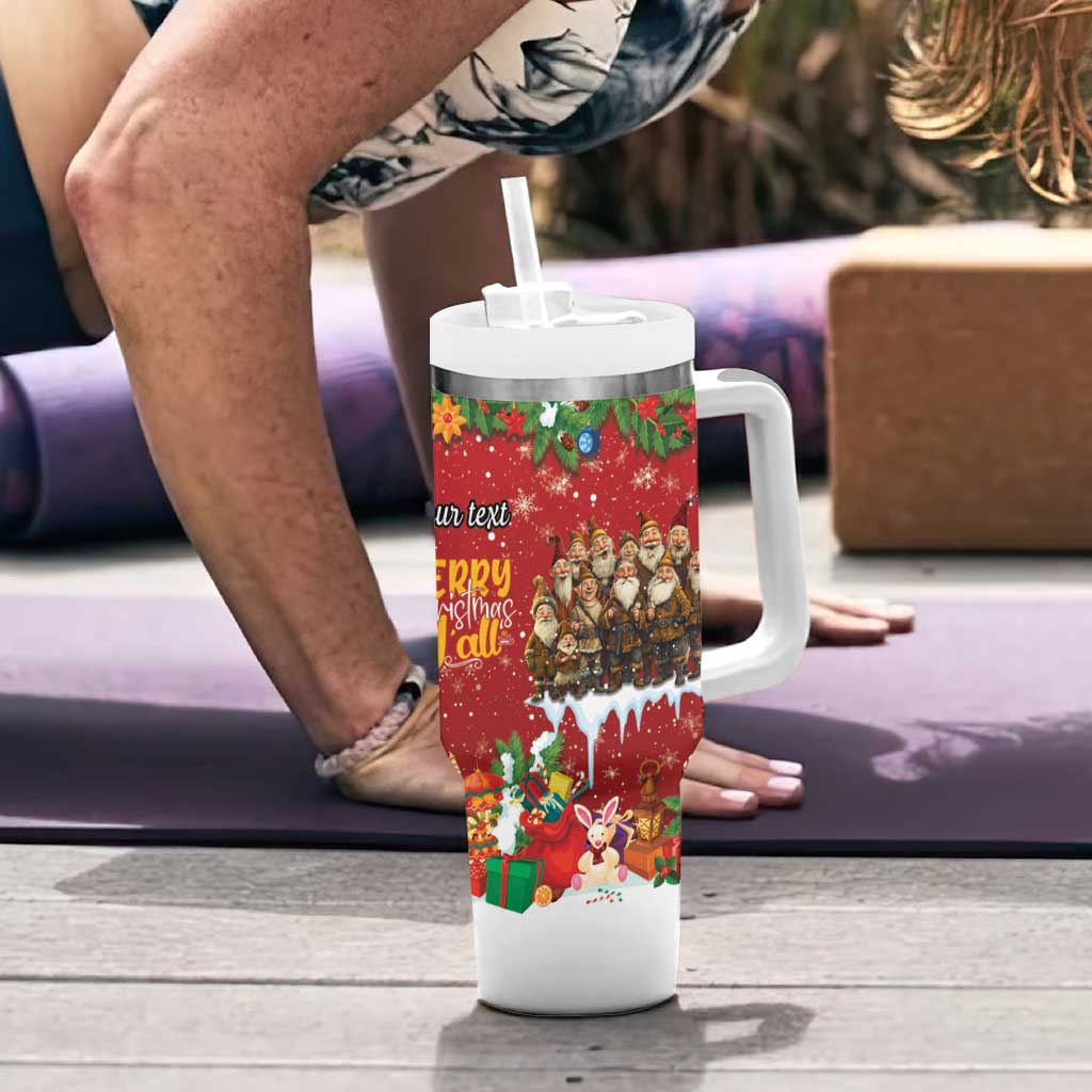 Red holiday tumbler with white handle and straw, festive character wrap on tabletop