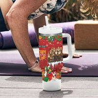 Red holiday tumbler with white handle and straw, festive character wrap on tabletop