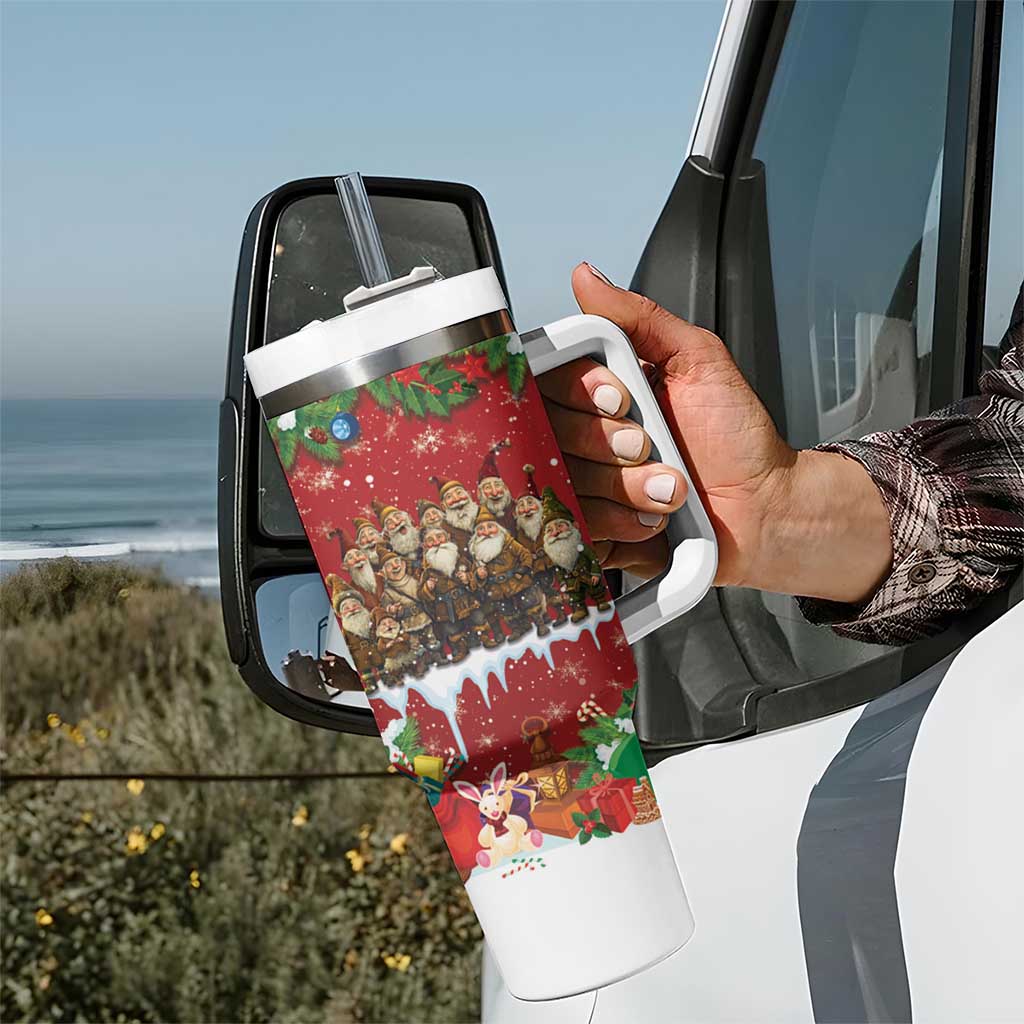 Red holiday tumbler with white handle and straw, held near car, festive character design