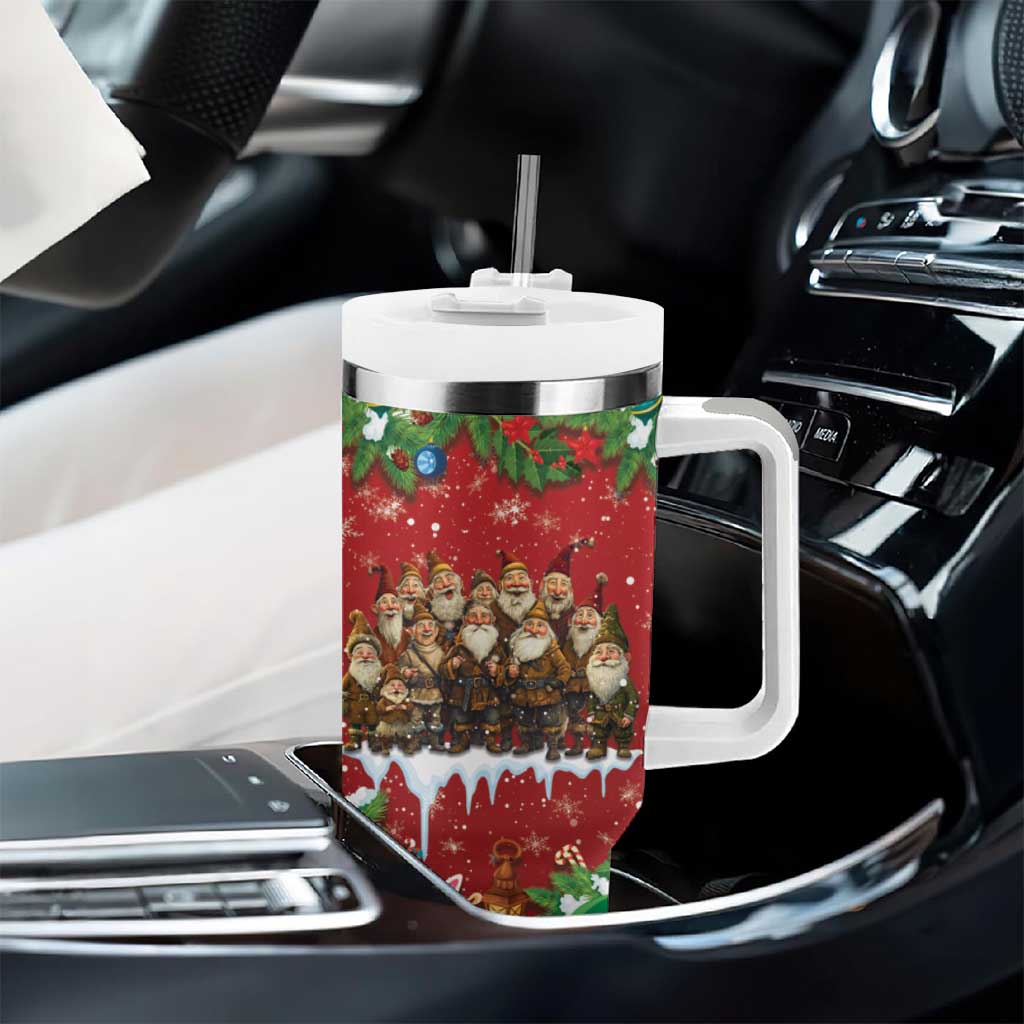 Red holiday tumbler with white handle and straw in car console, festive character wrap