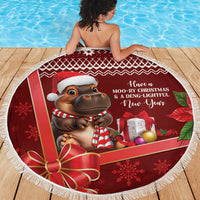 Red round beach blanket with white fringe, hippo wearing striped scarf and New Year text