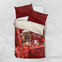 Red Christmas bedding set with cow mascot, gift box, poinsettia, and two red pillow covers