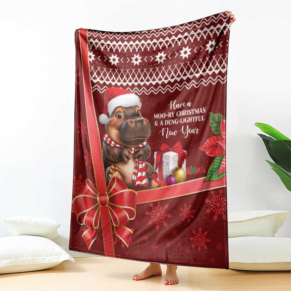 Red Christmas blanket draped with cartoon hippo, presents, and snowflake accents