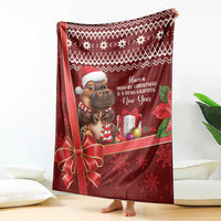 Red Christmas blanket draped with cartoon hippo, presents, and snowflake accents
