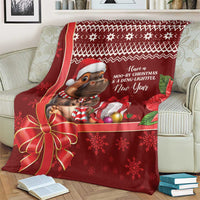 Red Christmas blanket with cartoon hippo in Santa hat, gifts, and snowflake motifs