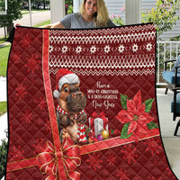 Red Christmas quilt on porch railing, quilted design, cartoon mouse and poinsettia holiday print