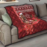 Red Christmas quilt draped over gray sofa, quilted texture, cartoon mouse with holiday text