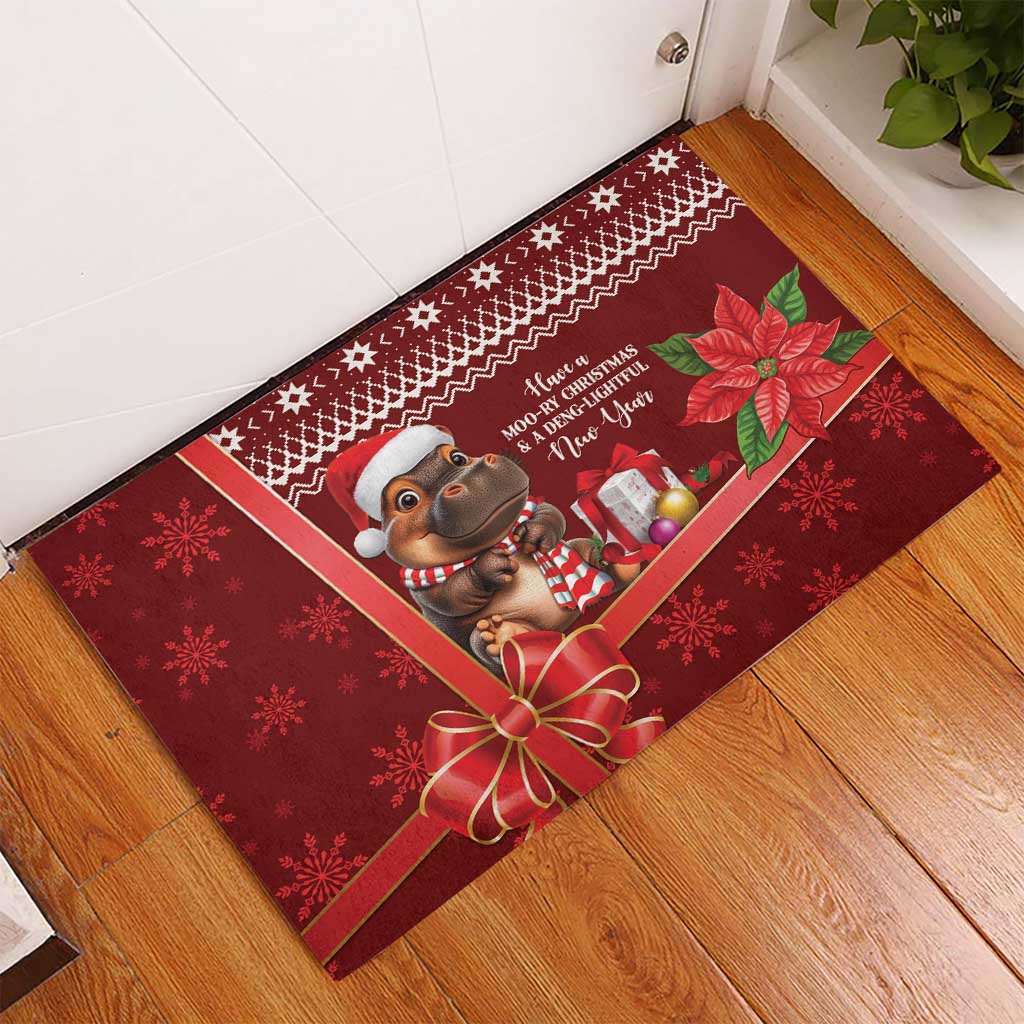 Red rubber Christmas doormat on wood floor, cow holding presents with poinsettias
