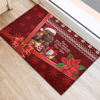 Red rubber Christmas doormat with cartoon cow, gifts, snowflake border, and poinsettias