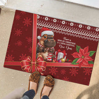 Red rubber Christmas doormat with cartoon cow, wreath bow, gifts, and poinsettias