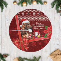 Red Christmas tree skirt with round design, cartoon cow graphic, and hanging bow accent
