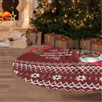 Round red Christmas tree skirt rug with fringed edge and cow holiday print, on floor