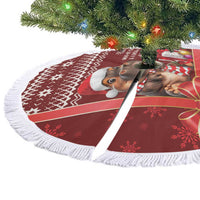 Red circular Christmas tree skirt with white fringe trim and cow graphic, shown from side