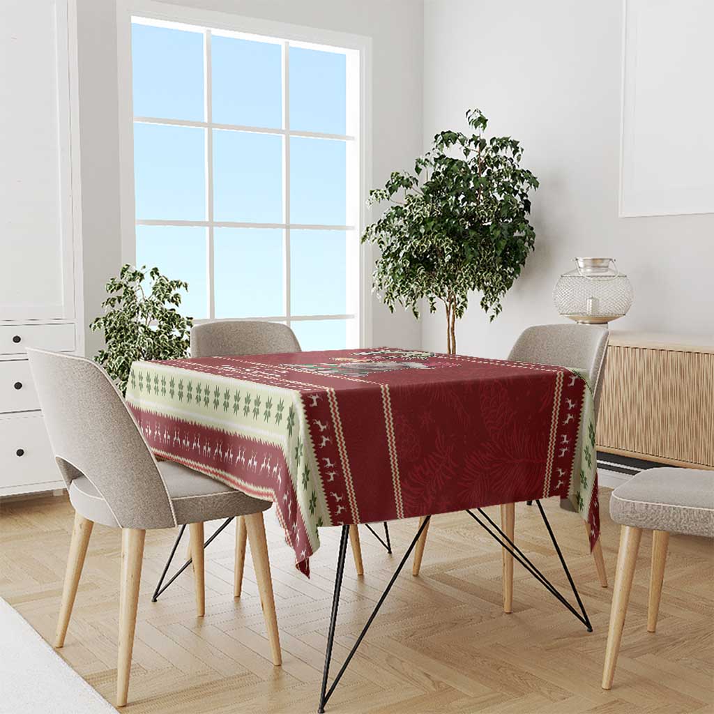 Red holiday tablecloth with Santa baby hippo and green leaf trim