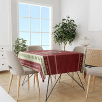 Red holiday tablecloth with Santa baby hippo and green leaf trim