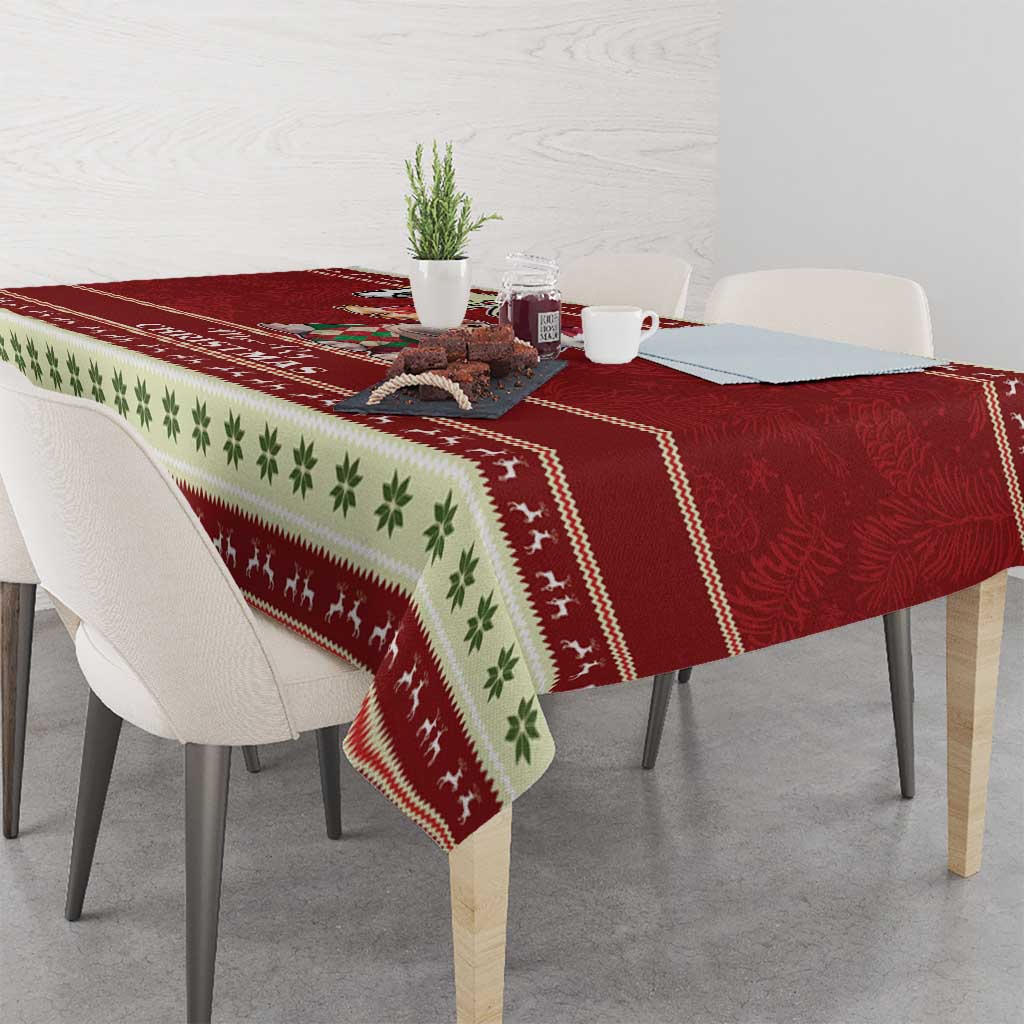 Red Christmas tablecloth with green leaf band and patterned reindeer border