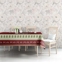 Red Christmas tablecloth with green leaf trim and Santa hippo scene