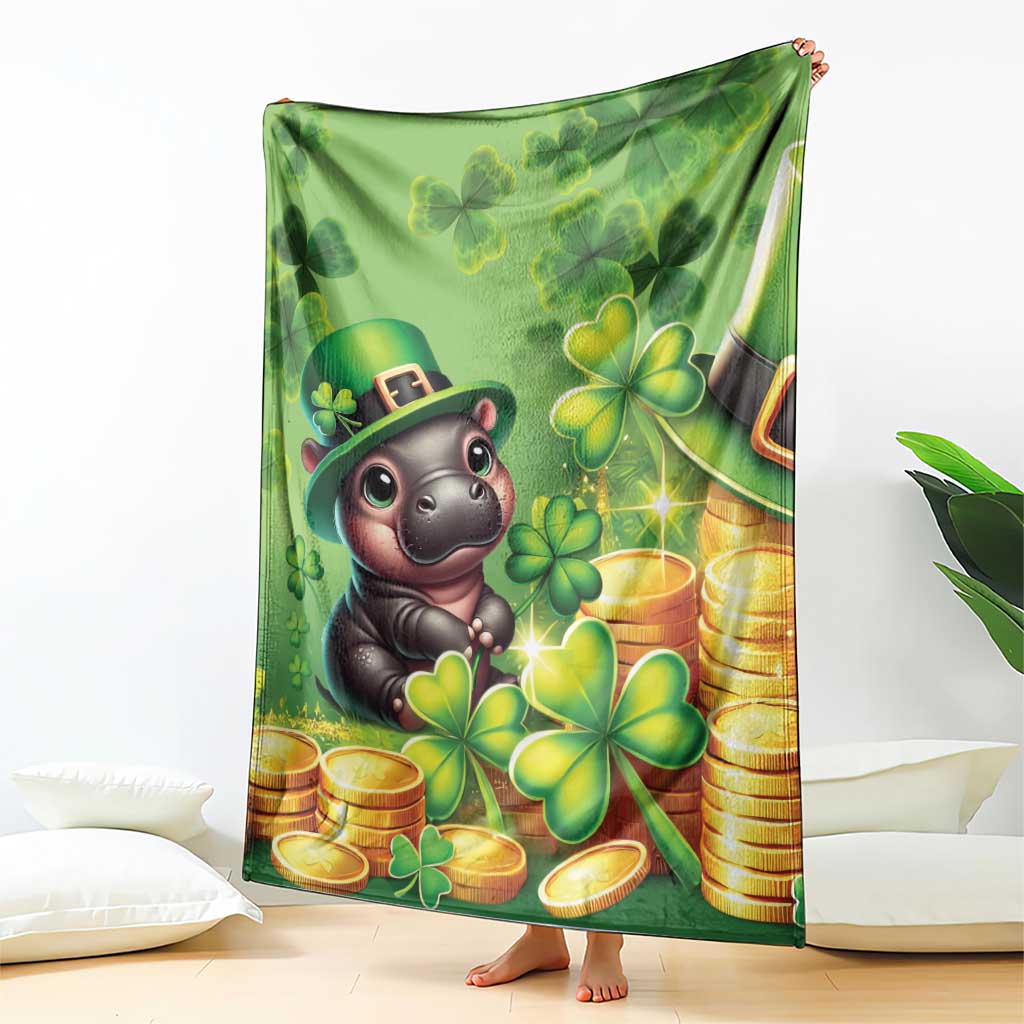 Green St. Patrick's Day blanket with cartoon hippo, clover and gold-coin design, held up