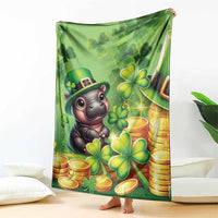 Green St. Patrick's Day blanket with cartoon hippo, clover and gold-coin design, held up