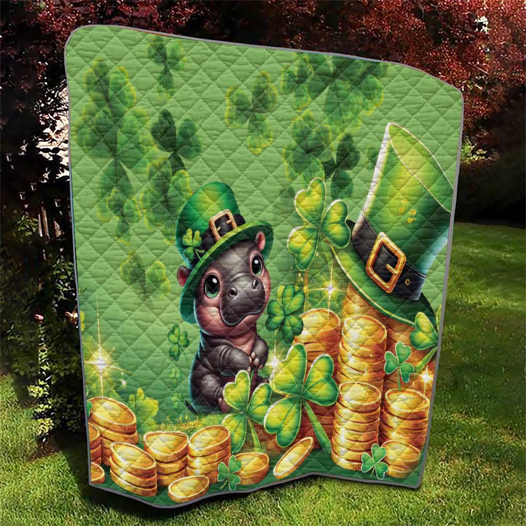 Green quilt with cartoon moose in leprechaun hat, shamrocks and stacked gold coins, quilted