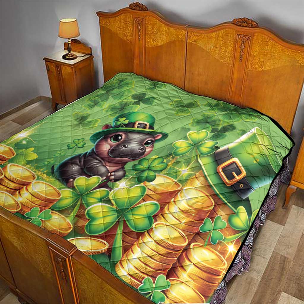 Green quilt on bed with cartoon leprechaun moose, clover flowers, and gold coin stacks