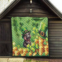 Green quilt with cartoon moose and leprechaun hat, shamrocks and gold coins, on outdoor porch