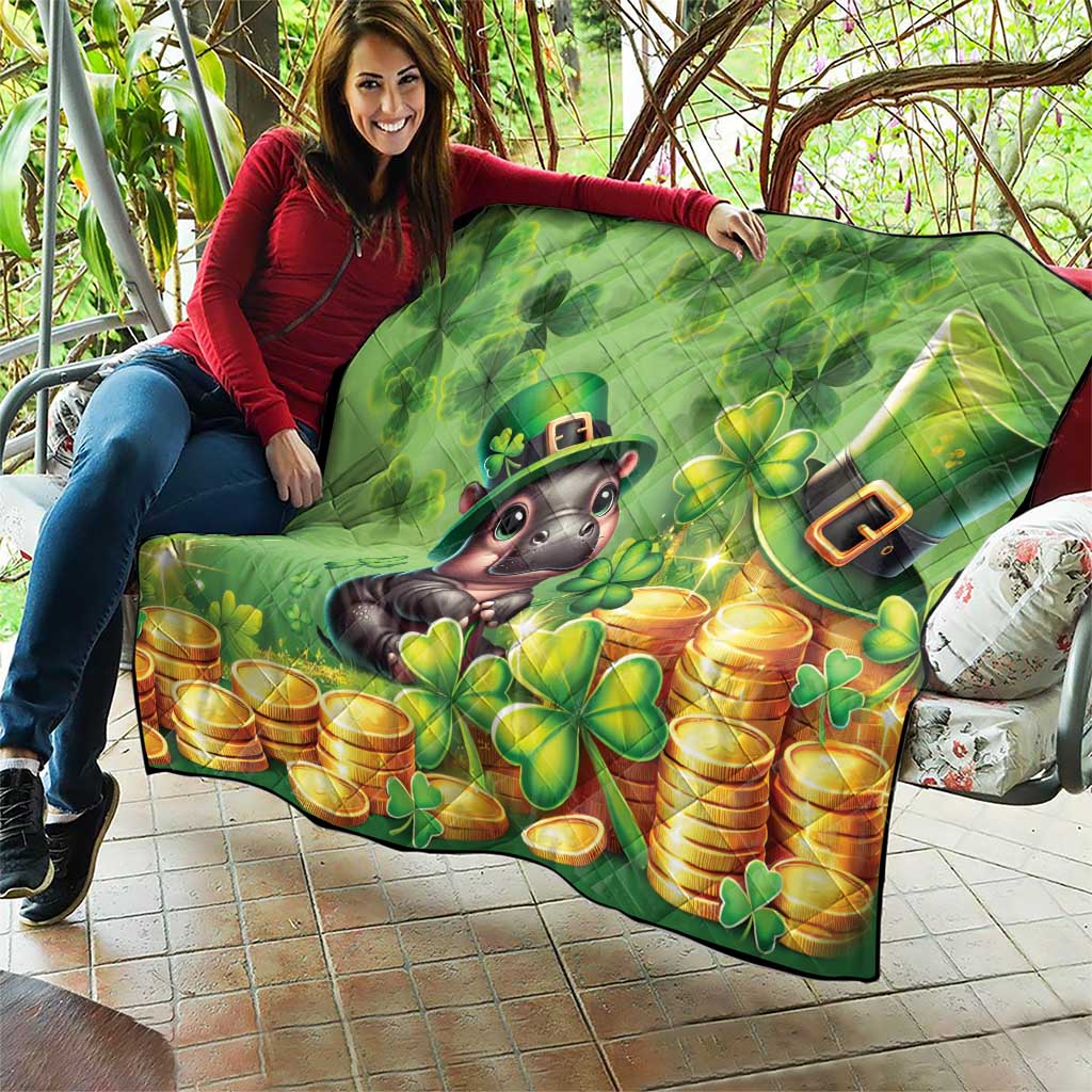 Green St. Patrick's Day quilt held up outdoors: cartoon moose, clovers, and gold coin piles
