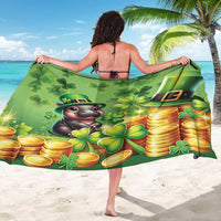 Green sarong displayed wide with clovers, coins, and cartoon leprechaun animal face