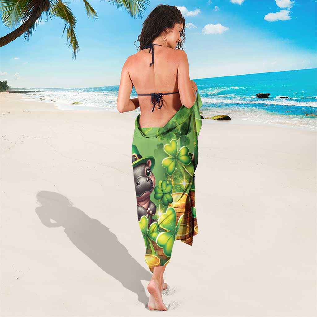 Green sarong with back-facing clover and coins print, tied at waist