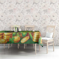 Green St. Patrick’s tablecloth with gold coins and shamrocks across table surface