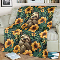 Green sloth and flower blanket draped over a sofa, featuring two sloths and yellow flowers